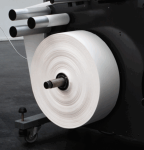 Large white paper sample roll mounted on a Tapio Analyzer, prepared for machine direction quality measurement.